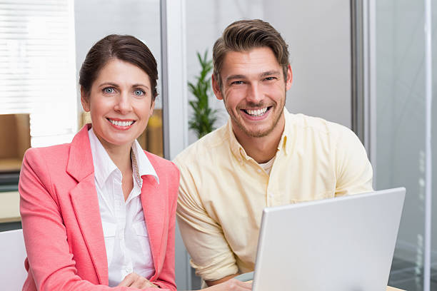 istock Business people working together on laptop and smiling 516651551