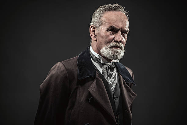 Vintage characteristic senior man with gray hair and beard. Vintage characteristic senior man with gray hair and beard. Studio shot against dark background. charles dickens stock pictures, royalty-free photos & images