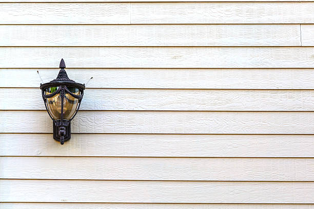 istock Lamp hanging on wooden wall background 516652557