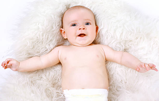 istock Funny cute baby lying in the bedroom 516653093