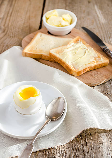 istock Boiled egg with crispy toasts on the wooden table 516653449