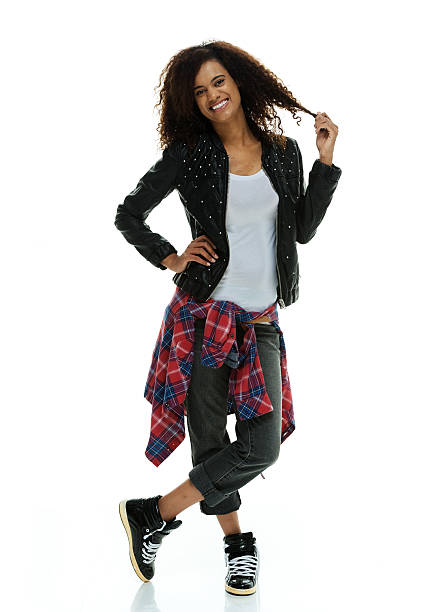 istock Cheerful woman standing & touching her hair 516653673