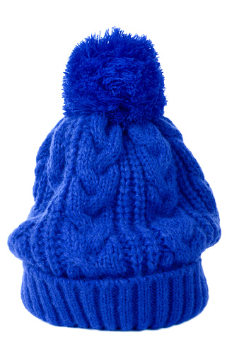 Blue bobble hat or knit hat isolated against a white background.