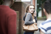 Teenage Girl Using Phone As She Feels Intimidated