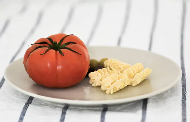 Tomato, paste and olives for a  Italian-style pasta