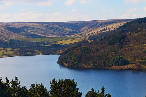 Stunning view across Scammonden Water, against a backdrop of rolling hills, on a crisp spring sunny morning, West Yorkshire, England