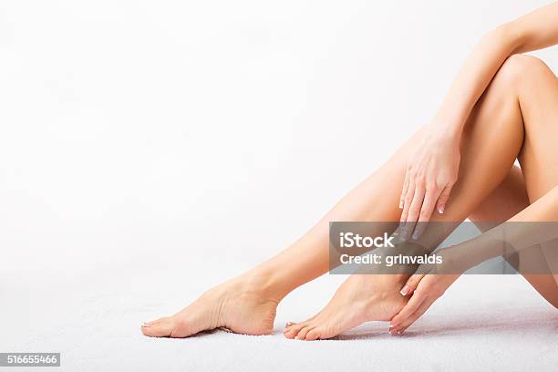 Female Taking Care Of Her Feet Stock Photo - Download Image Now - Women, Moisturizer, Cream - Dairy Product
