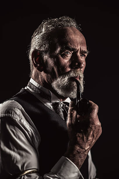 istock Pipe smoking vintage characteristic senior man with gray hair. 516656155