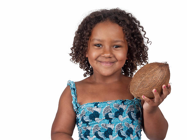 Little Ghanaian - Canadian Girl with coconut stock photo