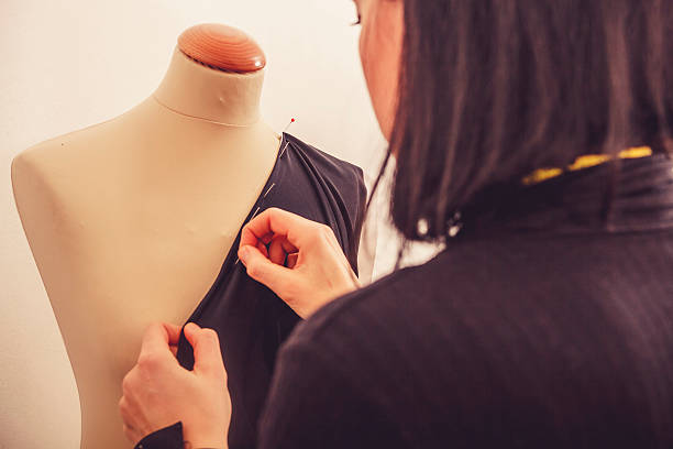 istock Fashion Designer Adjusting Cloth on Tailor's Dummy, Close-up 516656520