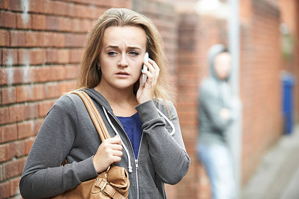 istock Teenage Girl Using Phone As She Feels Intimidated 516656827
