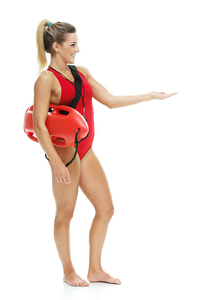istock Female lifeguard with life buoy presenting 516657139
