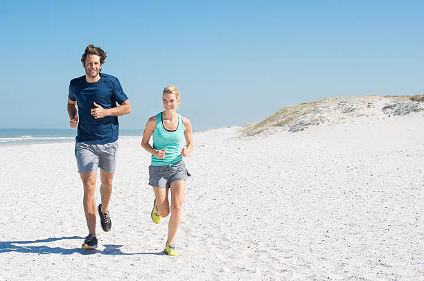 남자, 여자 땀복 - healthy lifestyle women beach looking at camera 뉴스 사진 이미지