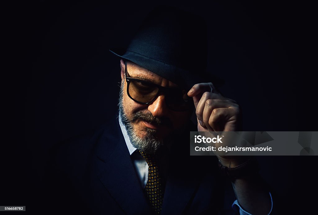 Greeting From a Beard Man Older beard man respectfully holding a hat, wearing a classic male clothes with tie. Actor Stock Photo