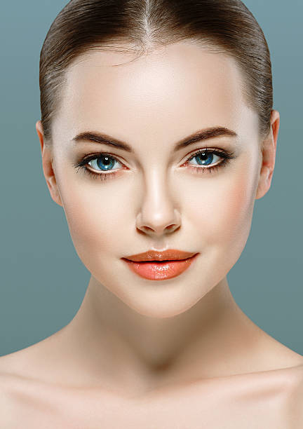 istock Beautiful woman portrait face close up studio gray background 516660982