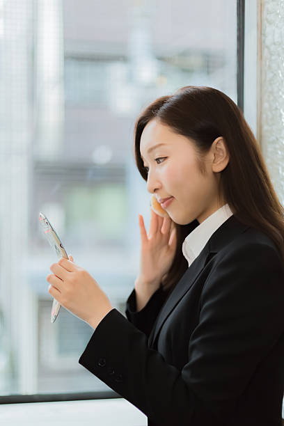 istock Young Woman applying foundation on face with cosmetic sponge 516661096