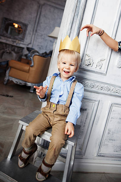 Prince cute baby smiling cheerful happy crown stock photo