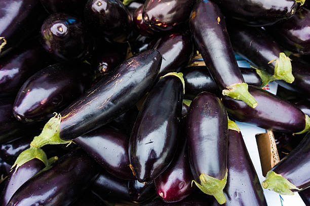 istock Fresh juicy aubergine.  eggplants at market 516680004