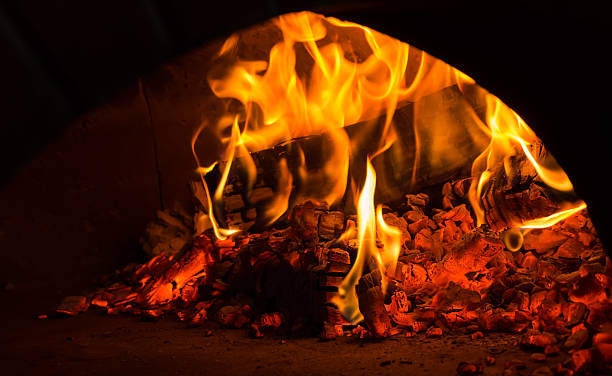 istock fire in the oven.  Traditional Pizza oven 516681718