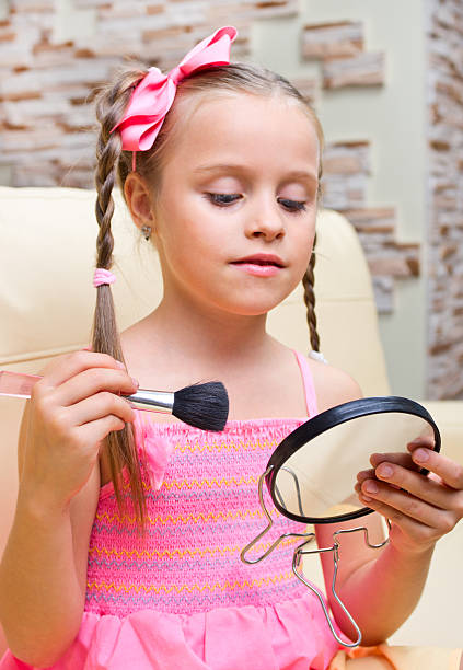 istock Little girl puts makeup 516681789