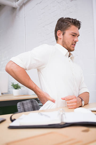 istock Businessman suffering from backache at office desk 516682055