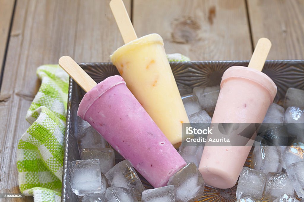 Fruit yogurt popsicles Fruits and berries yogurt mixed ice cream popsicles Berry Fruit Stock Photo