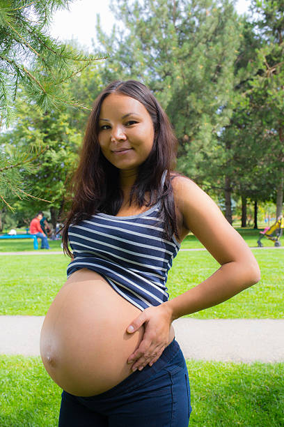 istock Pregnant girl walking in park 516683061