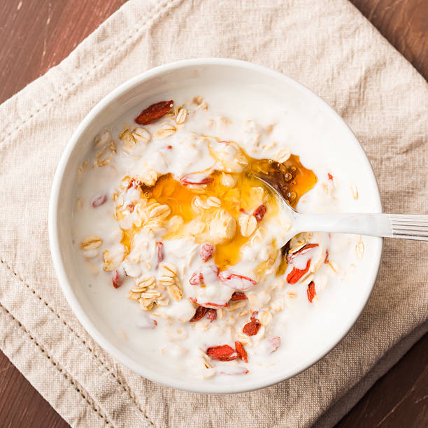 Smoothie bowl with natural yogurt, goji berries, oatmeal flakes and honey
