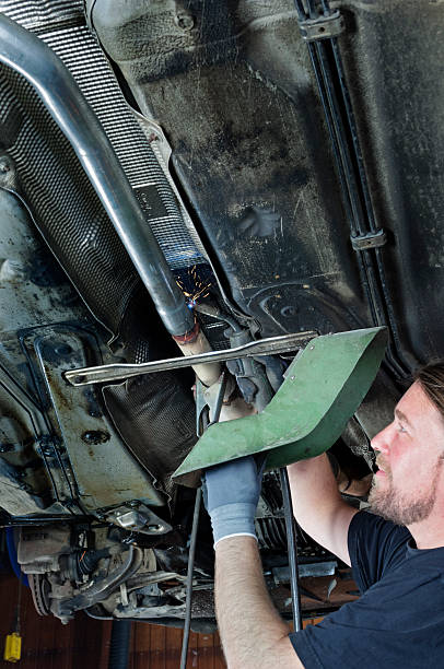 istock Mechanic At Work Welding The Undersde of a Car 516683734