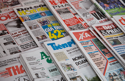 Hanoi, Vietnam - March 12, 2016: Many title of Vietnamese newspapers for sale at a news stand in Hanoi capital street.