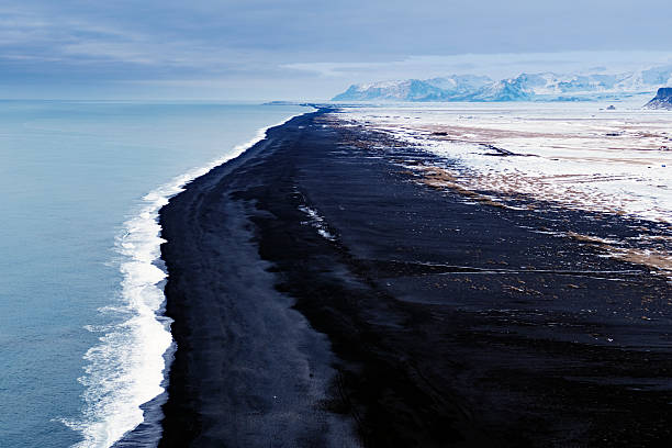 istock Volcanic black sand beach, view from Dyrholaey,Iceland 516683920