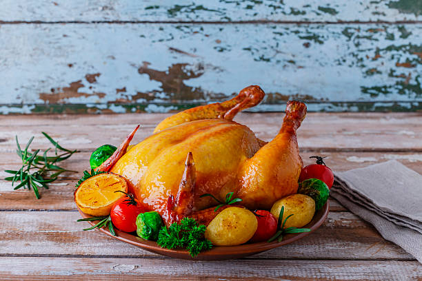 istock baked whole chicken with vegetables 516684563