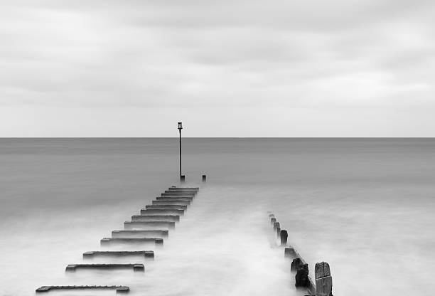 istock Black and white long exposure landscape image of sea 516684622