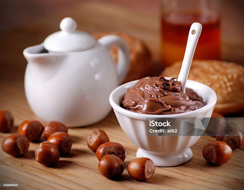 chocolate cream in the bowl chocolate cream and hazelnuts in the white bowl Bowl Stock Photo