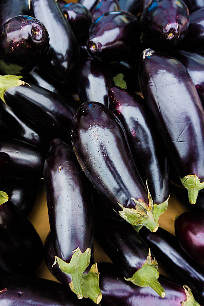 istock Fresh juicy aubergine.  eggplants at market 516685936