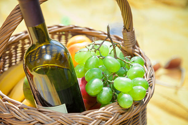 istock Wine and fruit in picnic basket. 516686192