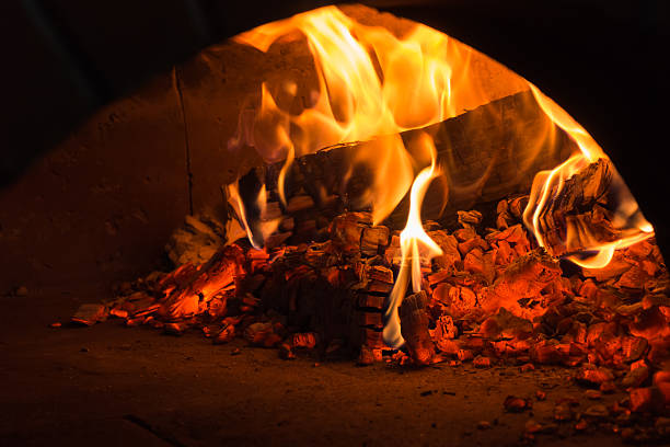 istock fire in the oven.  Traditional Pizza oven 516687352