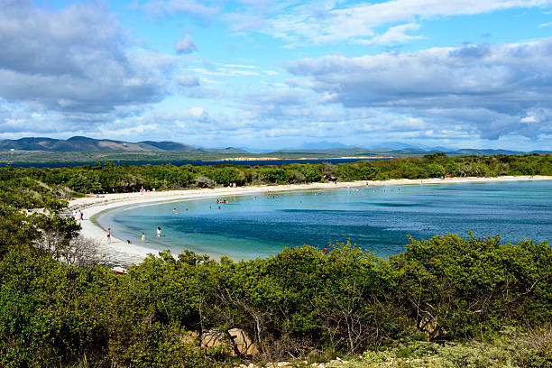 People enjoying the day at the beach. Puerto Rico Large number of people enjoying the day at the white sand beach of Cabo Rojo National Wildlife Refuge, Puerto Rico. cabo rojo puerto rico stock pictures, royalty-free photos & images