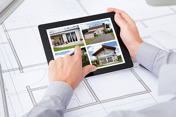 istock Digital Tablet Over Blueprint Browsing Pictures Of House 516687475