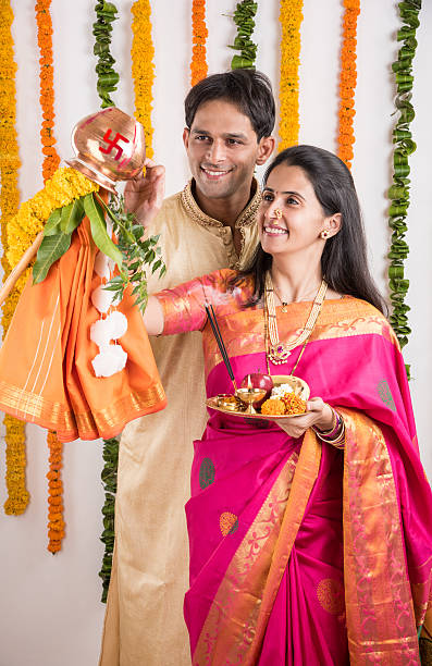 istock smart indian couple performing gudhi padwa puja 516687654