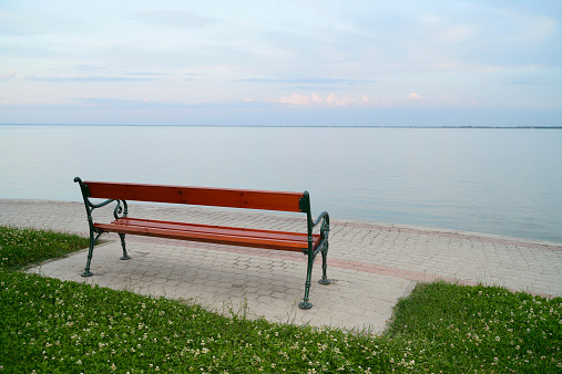 Wooden bench on the shore of Lake Balaton (Hungary) before sunset.