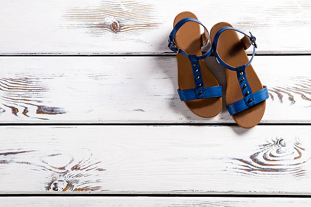 istock Female sandals on wooden shelf. 516688170