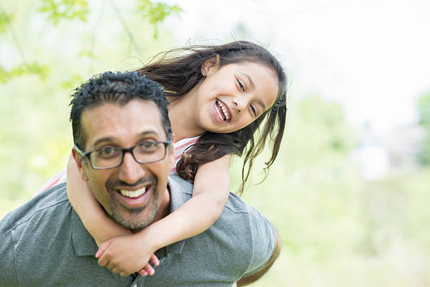 istock Father Giving His Daughter a Piggy Back Ride 516688742