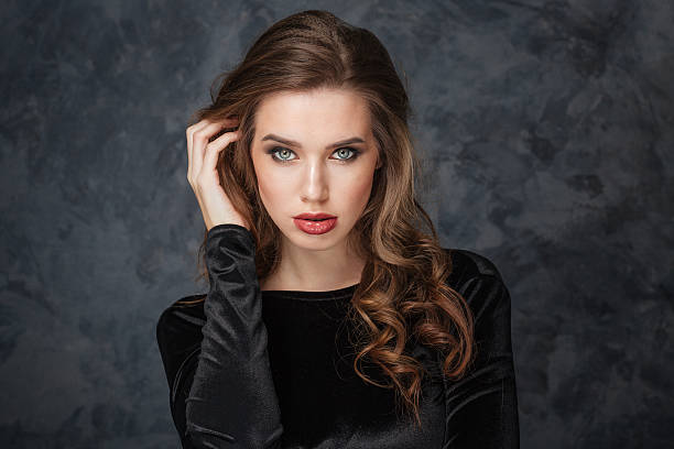 istock Sensual young woman touching her hair by hand 516688848