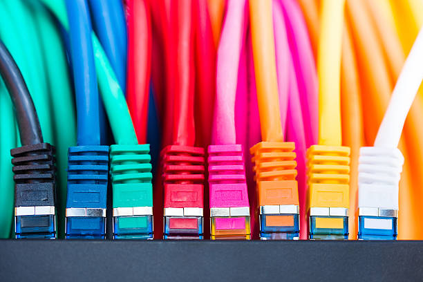 Network Cables Colorful network cables connected to a switch network connection plug stock pictures, royalty-free photos & images