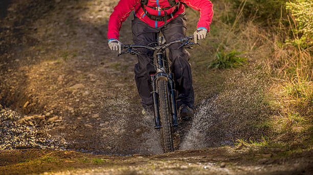 istock Woman enjoying mountain biking 516690034