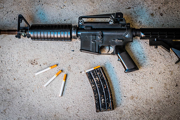 istock cigarette in Magazine gun.Customizable dark tones. 516690058