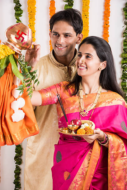 istock smart indian couple performing gudhi padwa puja 516691092