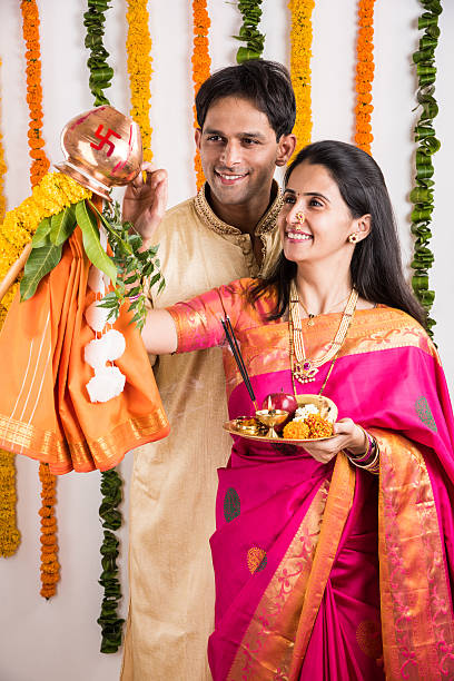 istock smart indian couple performing gudhi padwa puja 516691686