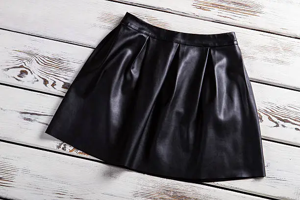 Photo of Black leather skirt with folds.